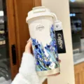 Insulated vacuum travel mug with floral design aesthetic portable coffee cup with lid and strap - Garden Series Blue