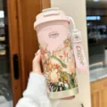 Pink insulated vacuum travel mug with floral design, dual-drinking lid and portable strap. - Garden Series Pink