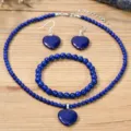 Detailed view of blue gemstone jewelry set including heart necklace, bracelet, and earrings. - Lapis Lazuli