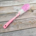 Long handle cleaning brush with pink handle and dense bristles for deep cup and bottle washing. - Pink