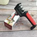 Detail view of the 3-stage manual knife sharpener with packaging box on wooden table. - Three-Stage Boxed