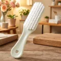 Plastic cleaning brush for shoes and laundry with soft white bristles and ergonomic handle. - Green