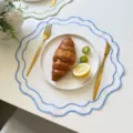 Round embroidered placemat with blue scalloped edge, ideal for table decor and photography. - 38cm Approx 25g / Sky Blue