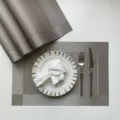 Detail shot of grey woven PVC placemat featuring heat insulation and non-slip design for dining tables. - Dark Silver-Gray Single Frame