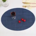 Blue oval PVC placemat for dining table, anti-slip heat insulating textured table mat. - 45x32cm / Dark Blue