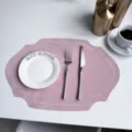 Elegant pink faux leather oval placemat with delicate stitching, perfect for stylish table decor. - Embroidered Border Rose Pink