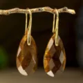 Elegant gold hook earrings featuring faceted teardrop brown gemstone pendants for women. - Tiger's Eye