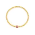 Primer plano de una pulsera de cuentas doradas con un dije rojo del ojo del mal - Estilo Rojo (JSS240029A)