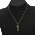 Green hexagonal crystal pendant necklace featuring gold tone chain on black display stand. - Green Hexagonal Cylinder Crystal Pendant Necklace (N2103-02)