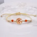 Braccialetto intrecciato in canapa fatto a mano con sfera in vetro di fiori secchi e perle. - Arancione