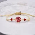 Bracciale in corda intrecciata fatto a mano con fiore secco rosso e ciondolo in resina, boho. - Rosso