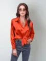 Orange satin blouse for women, stylish long sleeve button down top with front tie design. - Orange