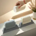 Detail view of window gap cleaning brush with grey scouring pad and plastic handle for sills. - Teal