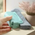 Close-up view of the window groove cleaning brush with a handle and gray sponge pad. - Gray