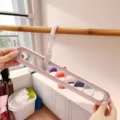 Detail van multifunctionele kledinghanger met 9 gaten, opvouwbaar magisch draaibaar rek. - Noords Blauw
