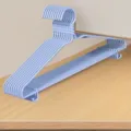 Detailopname van gestapelde lichtblauwe kunststof kledinghangers, stevig en praktisch ontwerp. - 40cm Platte Schouder met Haak / Blauw
