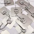Detail shot of stainless steel adhesive wall hook, brushed finish, punch-free traceless design. - 7x7cm / Brushed Silver