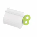 White Japanese style toothpaste squeezer with green roller, convenient manual dispenser. - Green