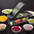 Black multi-functional vegetable cutter and chopper with clear container and diverse blades. - Gray