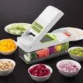 Multifunctional vegetable chopper and mandoline slicer with interchangeable blades for easy dicing. - White