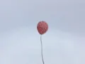 Close-up detail of a romantic pink rhinestone balloon car ornament with a sleek metal stem for decor. - Pink Balloon Style