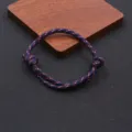 Detailed view of handmade adjustable paracord bracelet with navy blue red speckled nylon cord. - Braided Adjustable Style (BN-0279) / Navy Blue White Red