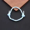 Light blue woven Milan cord bracelet detail featuring adjustable knot and sleek metal tips. - Light Blue