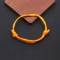 Orange paracord adjustable woven bracelet, handmade nylon nautical rope accessory detail view. - Braided Adjustable Style (BN-0279) / Orange