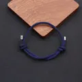 Handmade braided adjustable rope bracelet with metal tips, minimalist style for daily wear detail. - Navy Blue