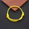 Detailed view of the yellow nylon paracord braided adjustable handmade bracelet cord. - Braided Adjustable Style (BN-0279) / Yellow