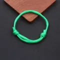 Green nylon paracord bracelet close-up, simple handmade adjustable woven rope detail view. - Braided Adjustable Style (BN-0279) / Fluorescent Green