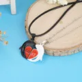 Detailed view of magnetic couple dolphin necklaces with split red heart and love text pendant. - Silver and Black Dolphin