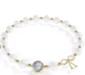 Elegant white beaded bracelet with gold spacers, round pendant, and a cute bow accent. - All White Premium Style