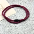 Detailed close-up view of the red braided magnetic couple bracelet featuring a secure black clasp. - Double-Layer Magnetic Clasp Wine Red