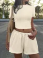 Detail view of the casual slim-fit crop top and drawstring shorts set worn outdoors. - S / Top And Bottom / Apricot