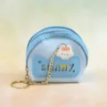 Detailed view of a mini half-round PVC coin purse with chain detail and cute pendant. - Blue
