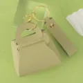 Mini leather handbag keychain in light green with gold hardware keyring and strap accessory. - Matcha Green