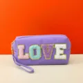 Detailed view of the purple cosmetic bag featuring colorful chenille LOVE letters and wrist strap. - love Series / 18X7X9CM / Purple