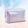 Detail shot of the glitter cosmetic bag showcasing the shiny surface, gold zipper, and pearl pull. - Solid Color / 18x7x11cm / Purple
