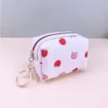 Detail view of the white waffle coin pouch featuring cute red strawberry prints and keyring. - 9X4X6cm / Red