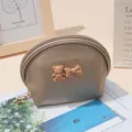 Detailed closeup of cute half-round cosmetic pouch with 3D bear bow and leather texture. - 14X7X10 / Pearlescent Finish