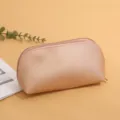 Minimalist leather cosmetic bag, solid color portable shell pouch for daily travel storage. - Gold