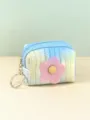 Close-up detail of the mini quilted gradient coin purse featuring a cute flower and key ring. - Blue