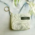 Close-up detail of a compact mini zipper coin purse with unique textured fabric and key ring. - 12*2.5*8.5CM / Apricot