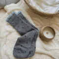 Grey knit mid-tube socks with black star patterns and light blue ruffled cuffs for women - One Size / Medium Grey