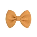 Close-up detail of a golden ribbed grosgrain ribbon bow hair clip for kids - Turmeric