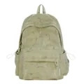 Detail view of the sage green schoolbag with a decorative white lightning bolt print pattern - Green