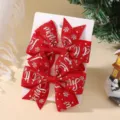 Pair of red Christmas bow hair clips with silver Let it Snow print on display card. - 2A-14 (Red Glitter Snowflake)
