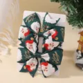 Set of two festive Christmas themed Santa Claus printed bow hair clips on display card - 2A-16 (Green Santa Claus)