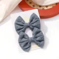 Pair of grey-blue fabric bow hair clips featuring delicate floral embroidery detail - Embroidered Floral Bow Hair Clip (19)
